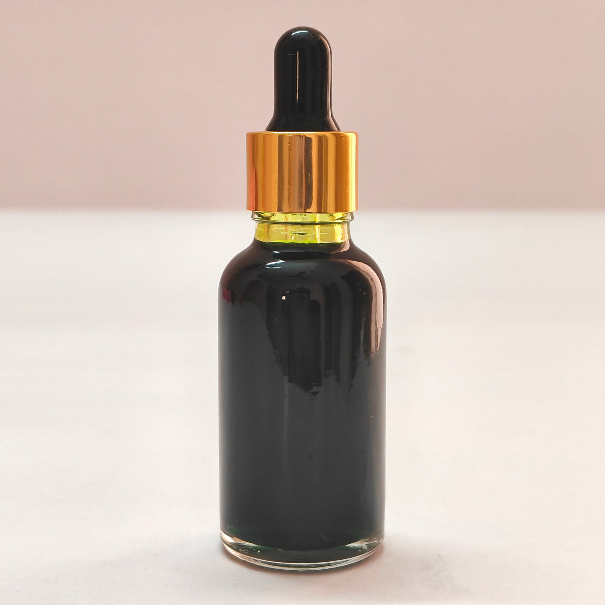 Liquid Food Color Green glass dropper bottle with gold cap on a white background