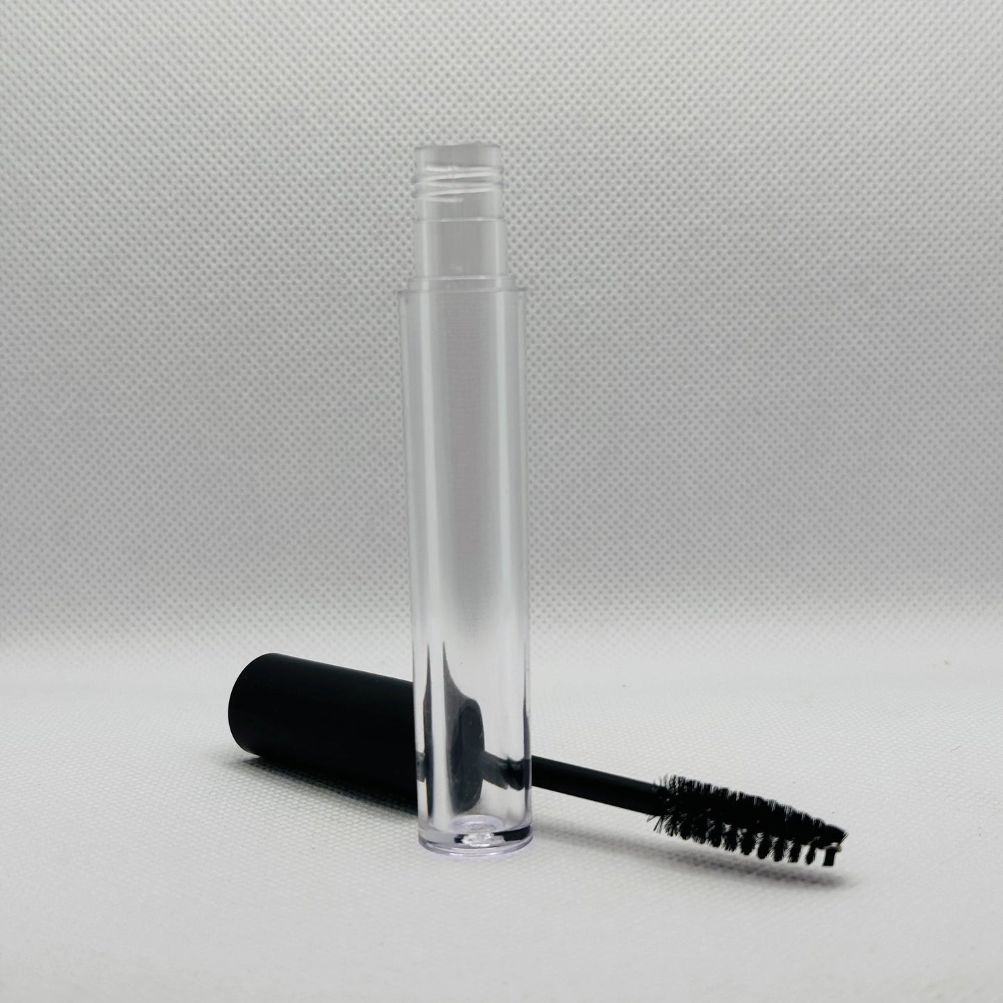 eyelash brush mascara container with white background