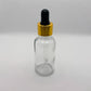Glass Serum Bottle - Clear - Gold Dropper - 15mL with white background