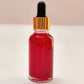 Red liquid dropper bottle on a white background
