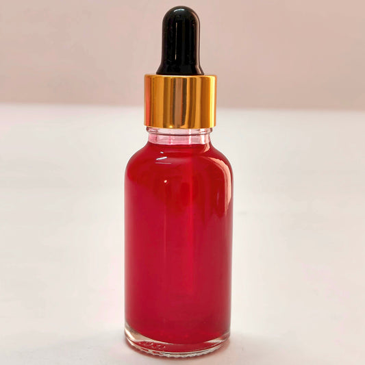 Red liquid dropper bottle on a white background