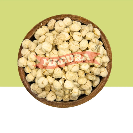 A top-down view of dried Medura (MoringaSeedKernel) seeds in a round wooden bowl, set against a split green and white background with a red 'MEDURA' brand watermark overlay.