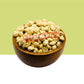 A wooden bowl filled with light beige dried MoringaSeedKernel, centered on a split green and white background with a red watermark across the middle.
