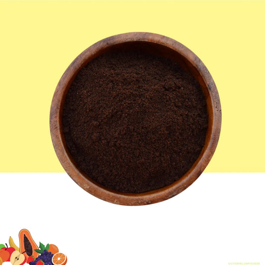 A wooden bowl filled with brown vanilla bean powder, placed on a yellow background.