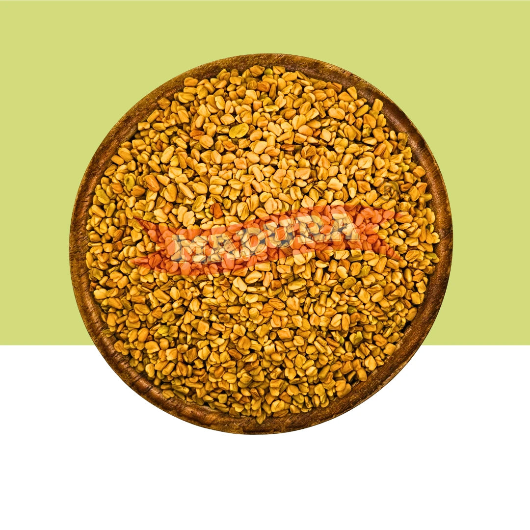 A top-down view of a round wooden bowl filled with small golden-brown dried seeds or grains, set against a split background of light green on the upper half and white on the lower half.